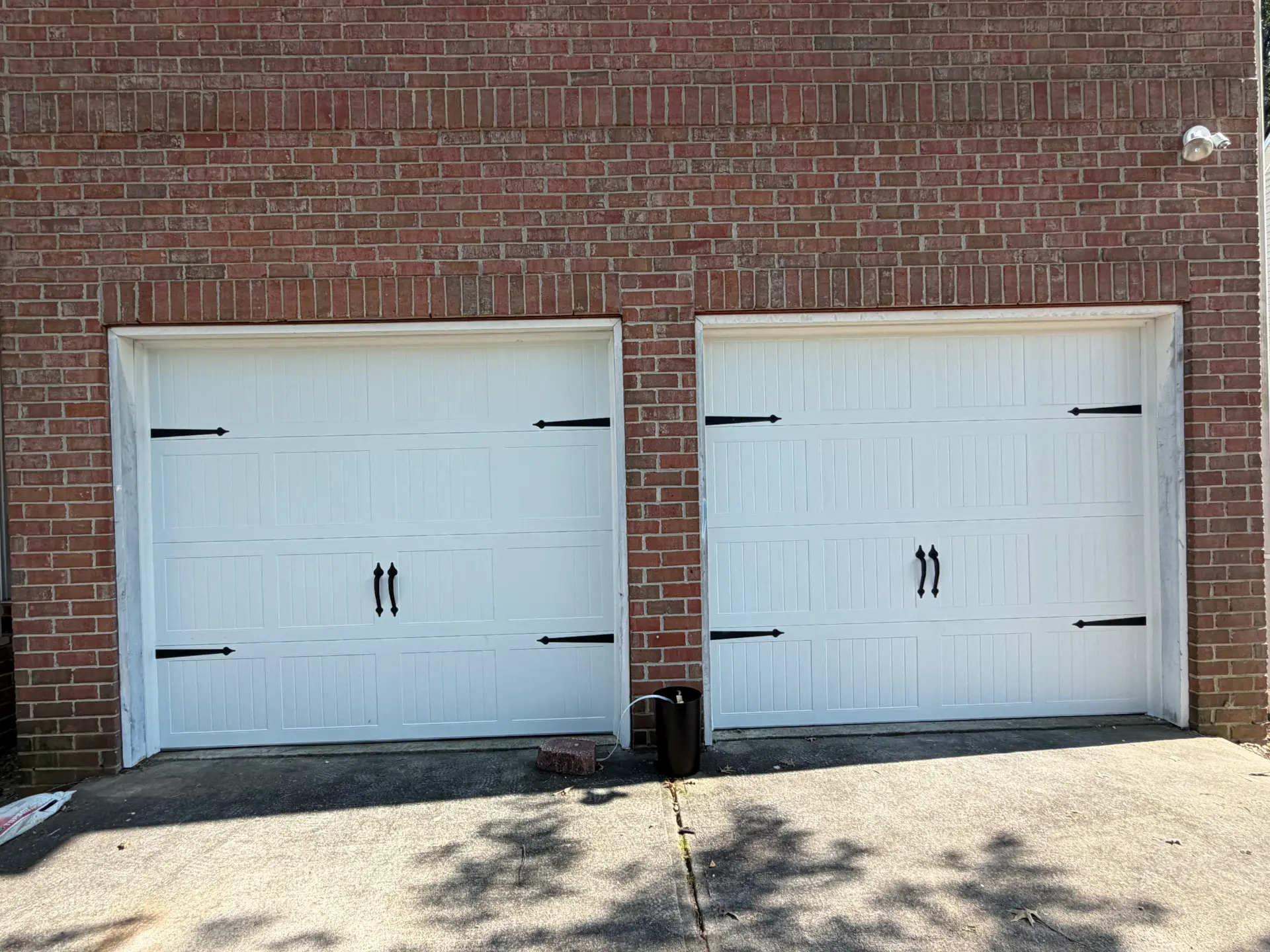 New garage door install — white dual-bay