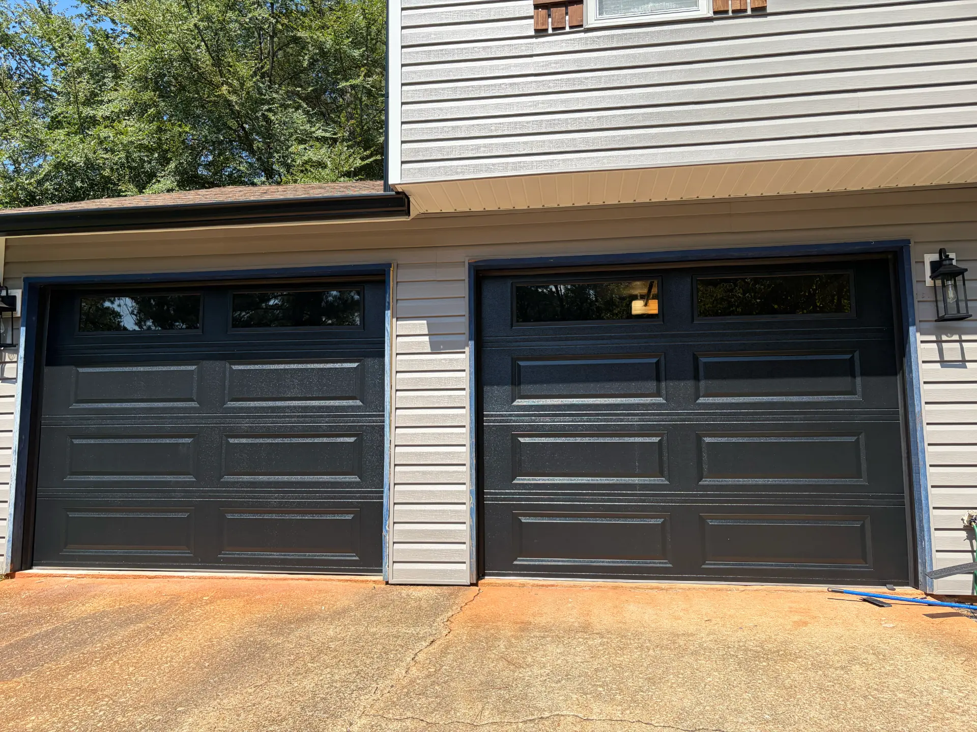 New garage door install — black dual-bay